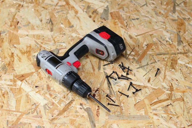 Screwdriver and screws on osb plywood royalty free stock image
